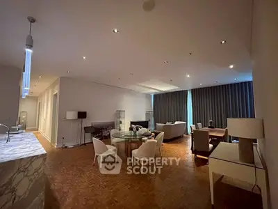 Spacious open-plan living room with elegant dining area and modern furnishings.