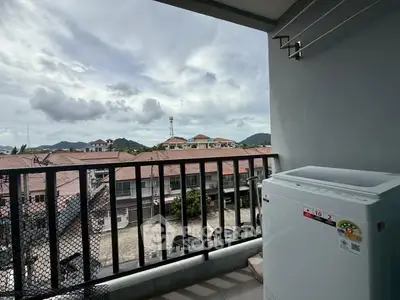 Charming balcony with scenic view and modern washing machine, ideal for urban living.