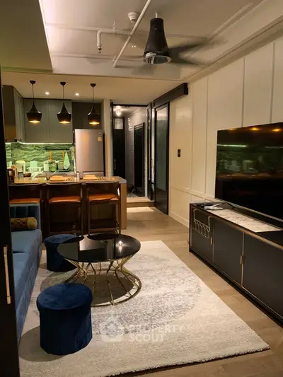 Modern living room with stylish decor, open kitchen layout, and ambient lighting.