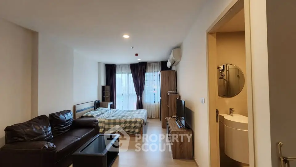 Modern studio apartment with cozy living area and stylish decor