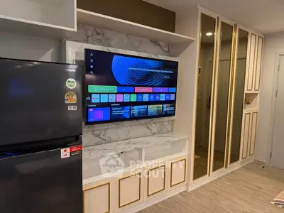 Modern living room with sleek TV setup and mirrored storage