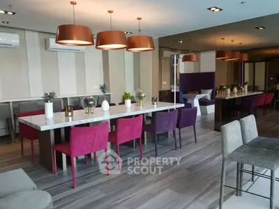 Luxurious modern dining area with stylish decor and vibrant chairs in a contemporary apartment.