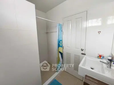 Modern bathroom with shower curtain and sleek sink design