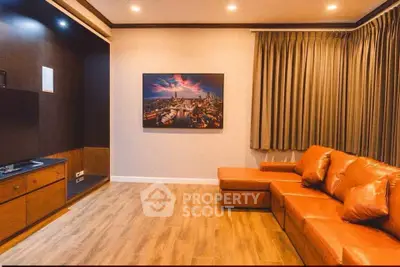 Stylish living room with leather sofa and cityscape artwork, perfect for modern living.