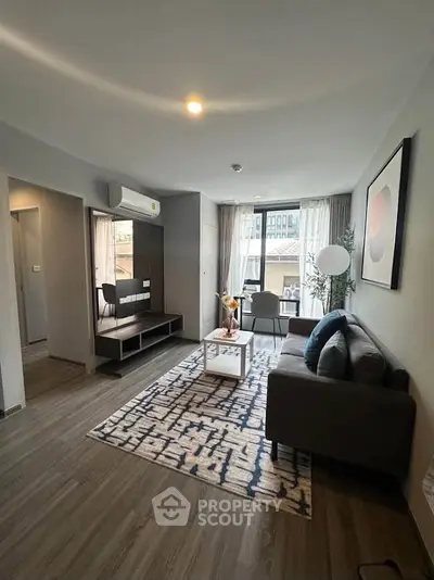 Modern living room with stylish decor and large windows in a contemporary apartment.
