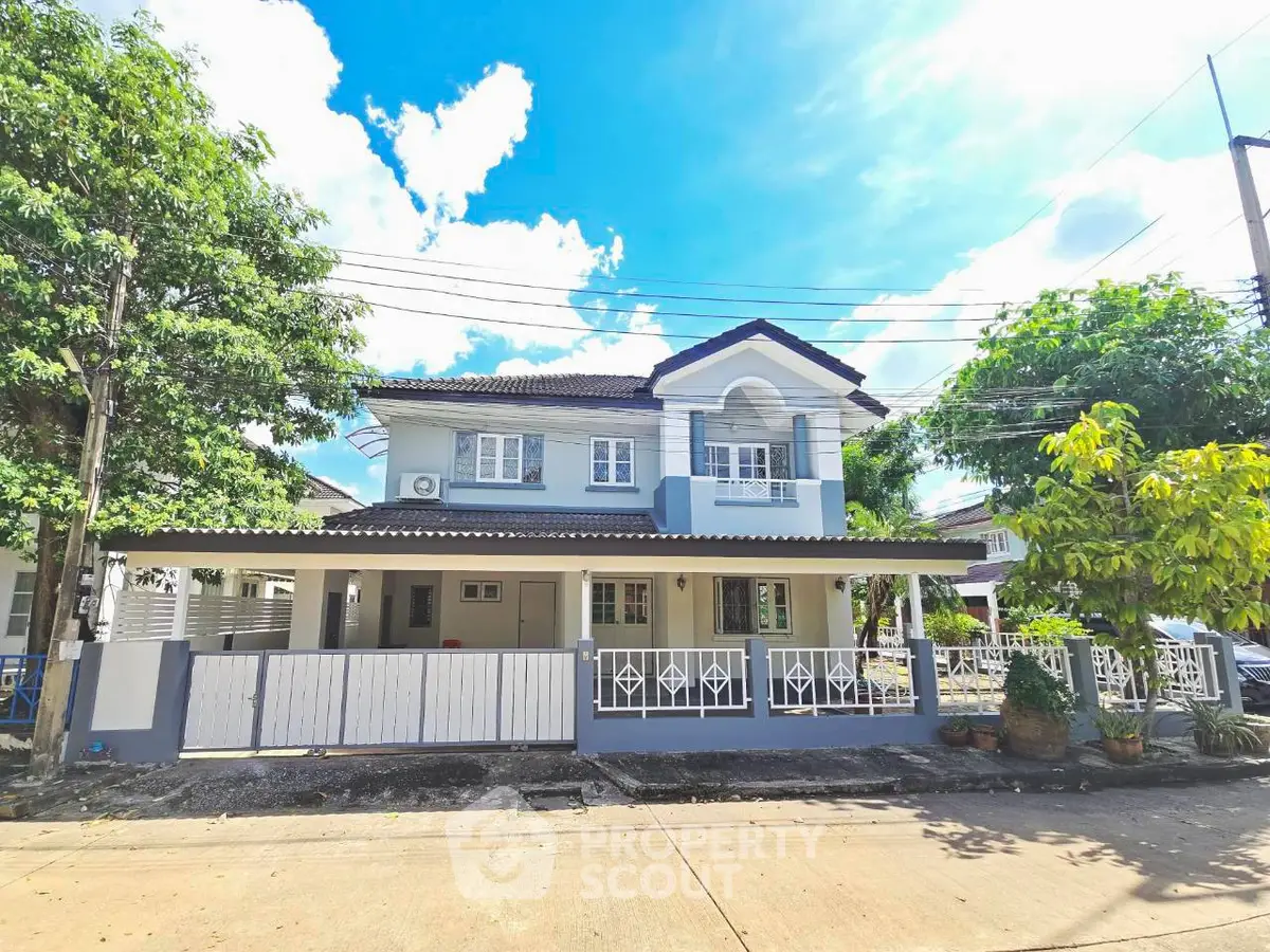 Charming two-story house with spacious front yard and elegant balcony in a serene neighborhood.