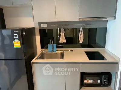 Modern compact kitchen with sleek appliances and stylish cabinetry