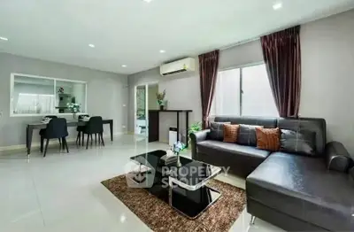 Spacious modern living room with sleek furniture and dining area, perfect for entertaining.