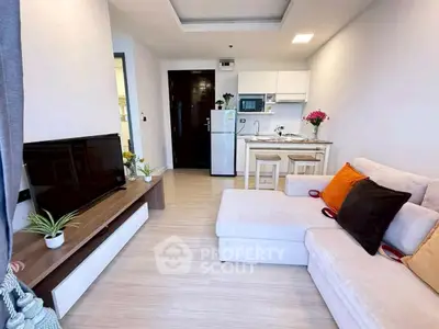 Modern living room with cozy sofa and open kitchen layout