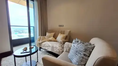 Cozy living room with plush seating and city view from balcony