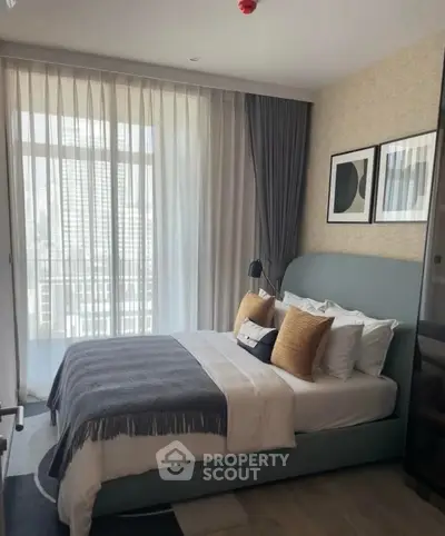 Modern bedroom with floor-to-ceiling windows and stylish decor in urban apartment.
