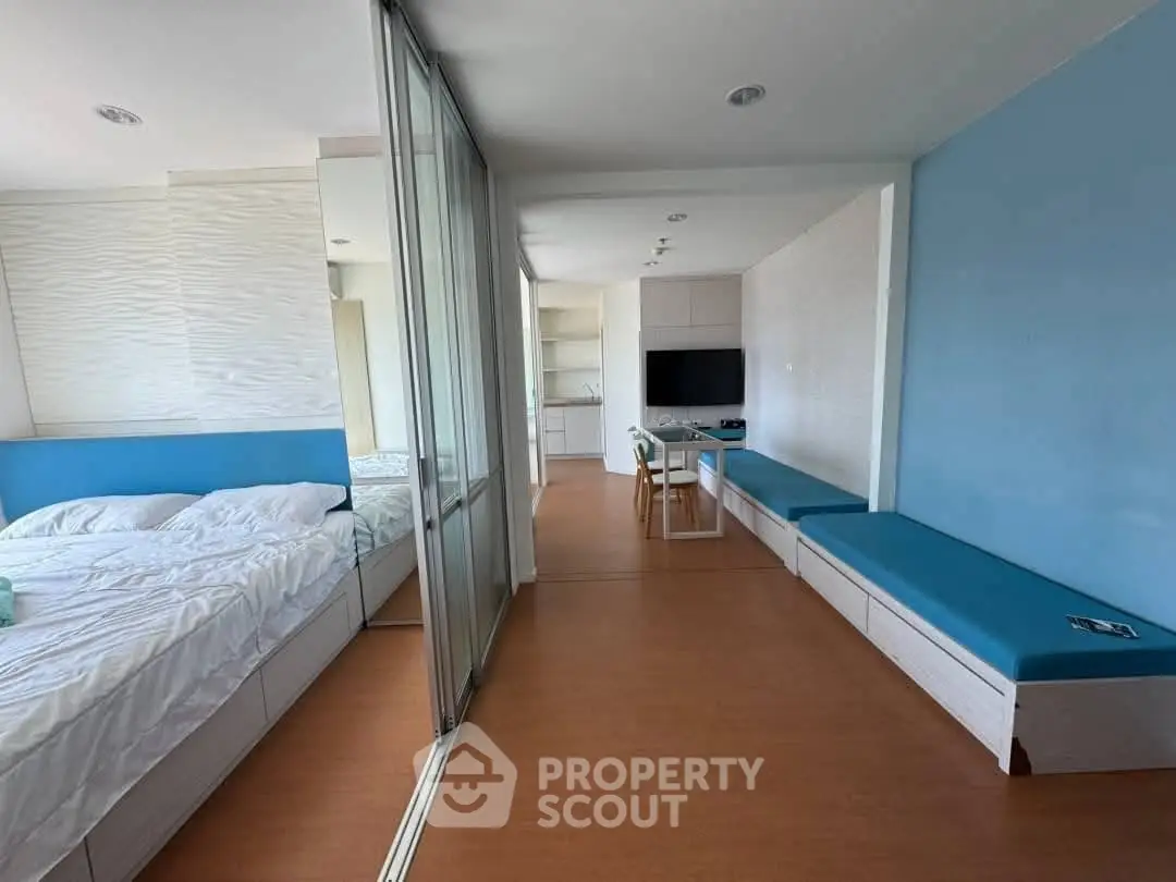 Modern studio apartment with blue accents and open layout