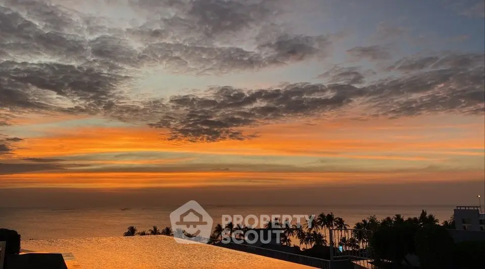 Stunning sunset view from luxurious infinity pool overlooking ocean