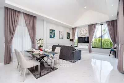 Luxurious modern living room with elegant dining area and large windows offering garden views.