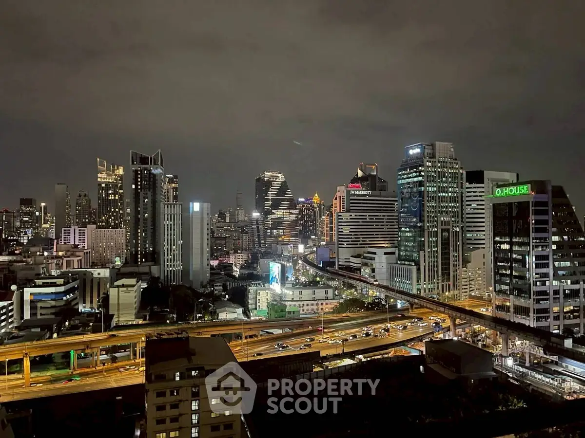 Stunning cityscape view showcasing vibrant urban skyline at night with illuminated skyscrapers.