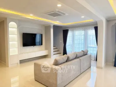 Spacious modern living room with elegant lighting and large sofa, perfect for relaxation and entertainment.