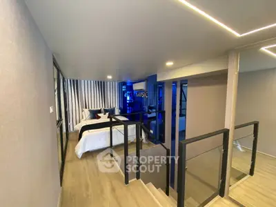 Modern bedroom with stylish decor and glass railing in a contemporary apartment.