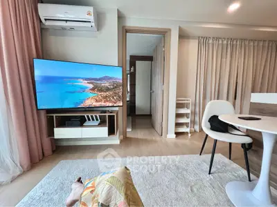 Modern living room with TV, air conditioning, and stylish furniture, perfect for relaxation and entertainment.