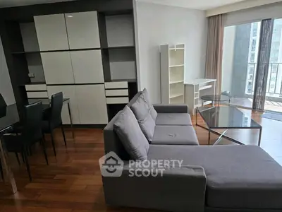 Modern living room with sleek furniture and large windows offering ample natural light.