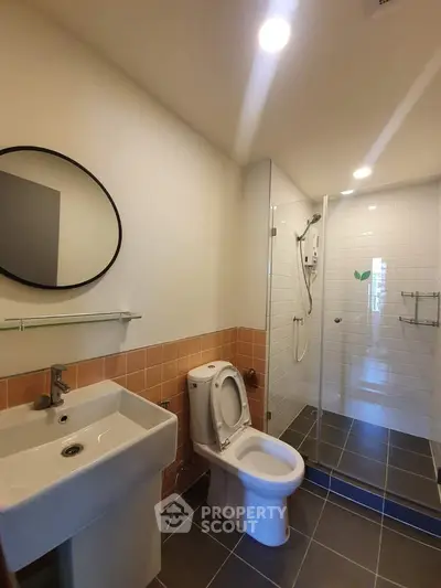 Modern bathroom with sleek fixtures and glass shower enclosure