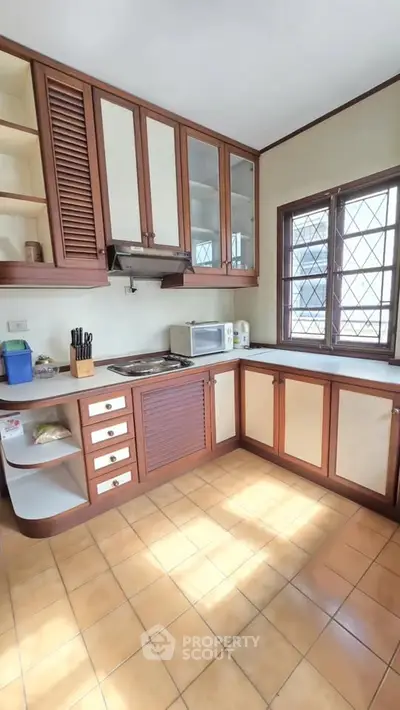 Charming kitchen with wooden cabinets and ample natural light