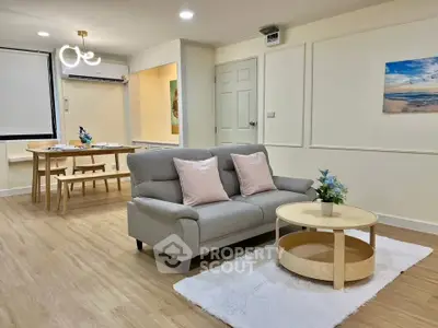 Spacious living room with modern decor and dining area, perfect for family gatherings.