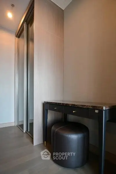 Stylish modern study nook with sleek desk and stool in elegant apartment.