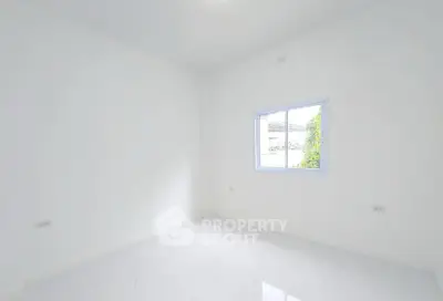 Bright empty room with white walls and window, ideal for customization.