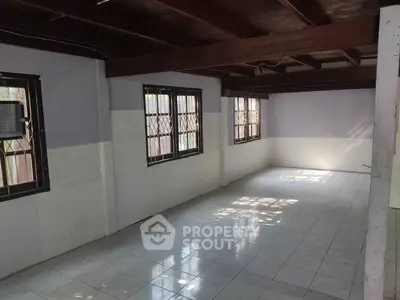 Spacious unfurnished room with tiled flooring and large windows, perfect for customization.