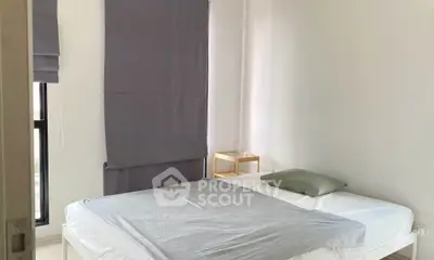 Modern minimalist bedroom with natural light and simple decor