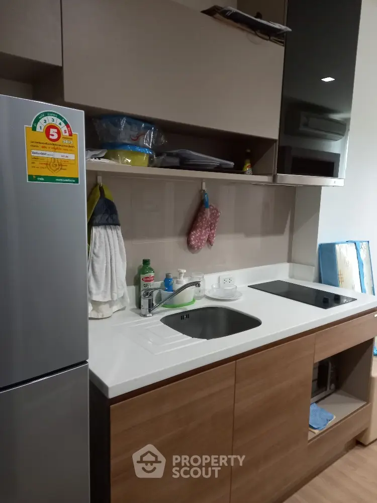 Sleek modern kitchen with built-in appliances, ample storage, and a clean, minimalist design perfect for culinary enthusiasts.