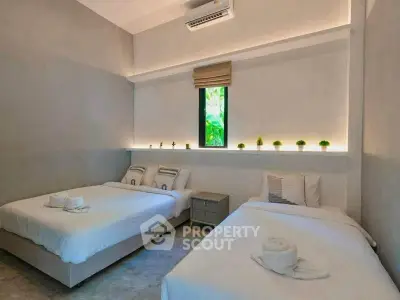 Modern bedroom with twin beds and ambient lighting