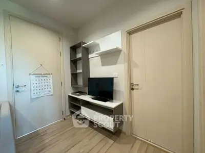 Modern living room with sleek TV stand and wall shelves, featuring a minimalist design.
