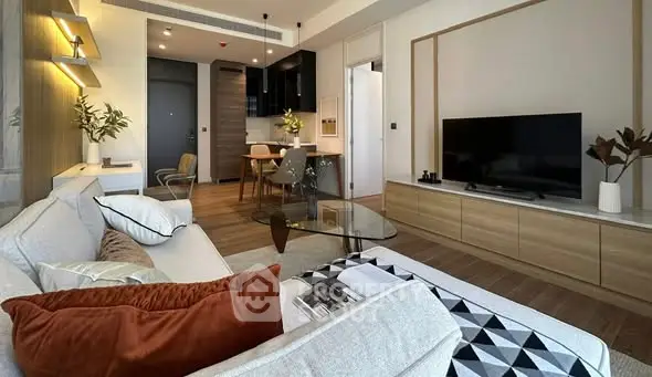 Modern living room with stylish decor and open layout, featuring a cozy sofa and sleek TV unit.