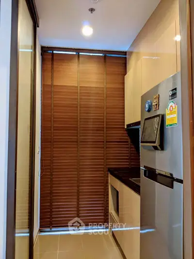 Modern kitchen with sleek appliances and stylish blinds