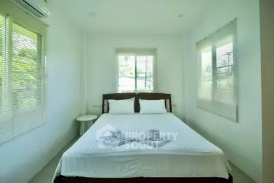 Bright and airy bedroom with large windows and minimalist decor