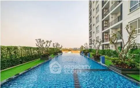 Luxurious apartment building with stunning pool and lush greenery