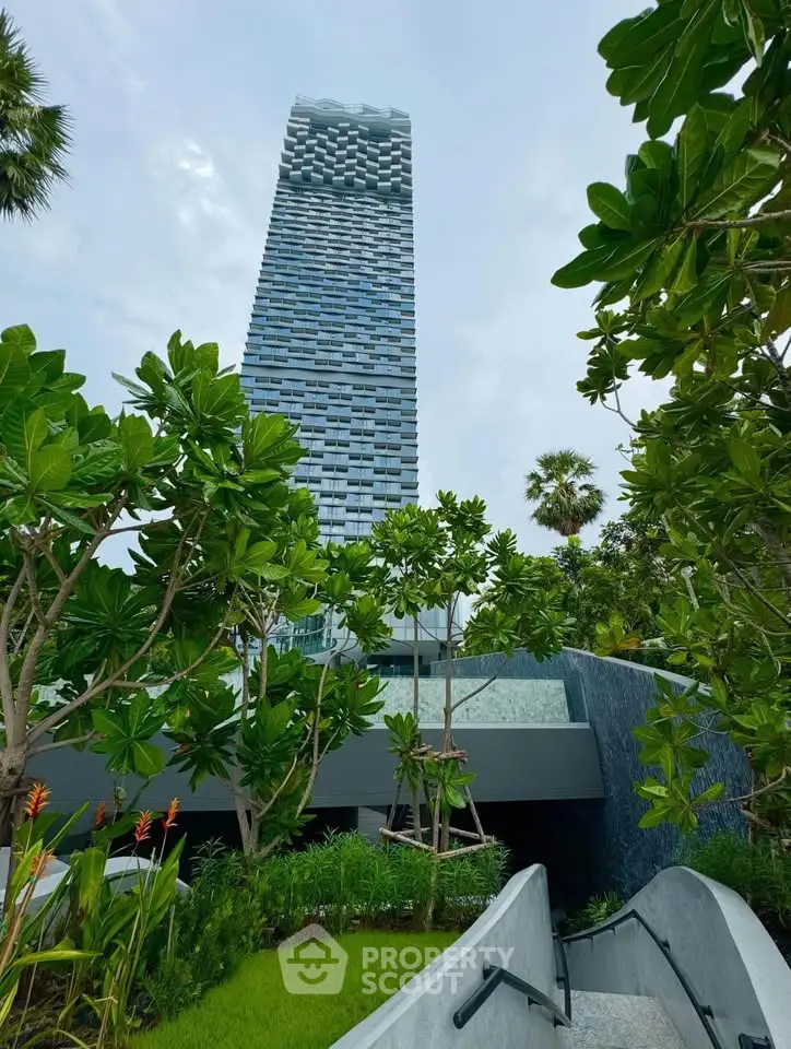 Stunning modern high-rise building with lush greenery and unique architectural design.