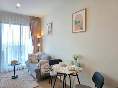 Chic modern living room with cozy sofa, stylish decor, and dining area in a bright apartment.