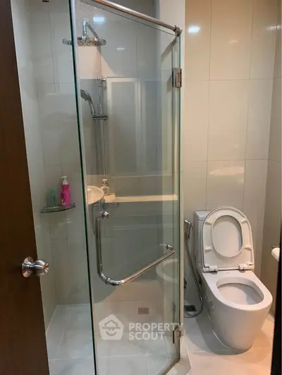 Pristine modern bathroom with glass shower enclosure and sleek fixtures, offering a clean and refreshing space for personal care routines.