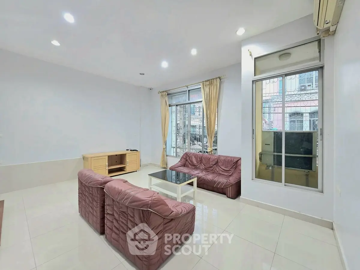 Spacious living room with modern furniture and large windows for natural light.