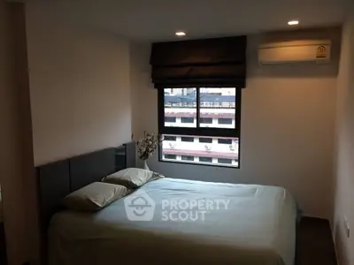 Cozy bedroom with modern decor and natural light from large window