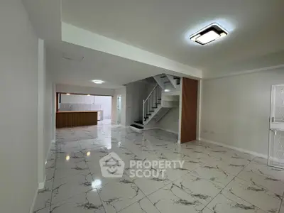 Spacious modern interior with marble flooring and stylish staircase