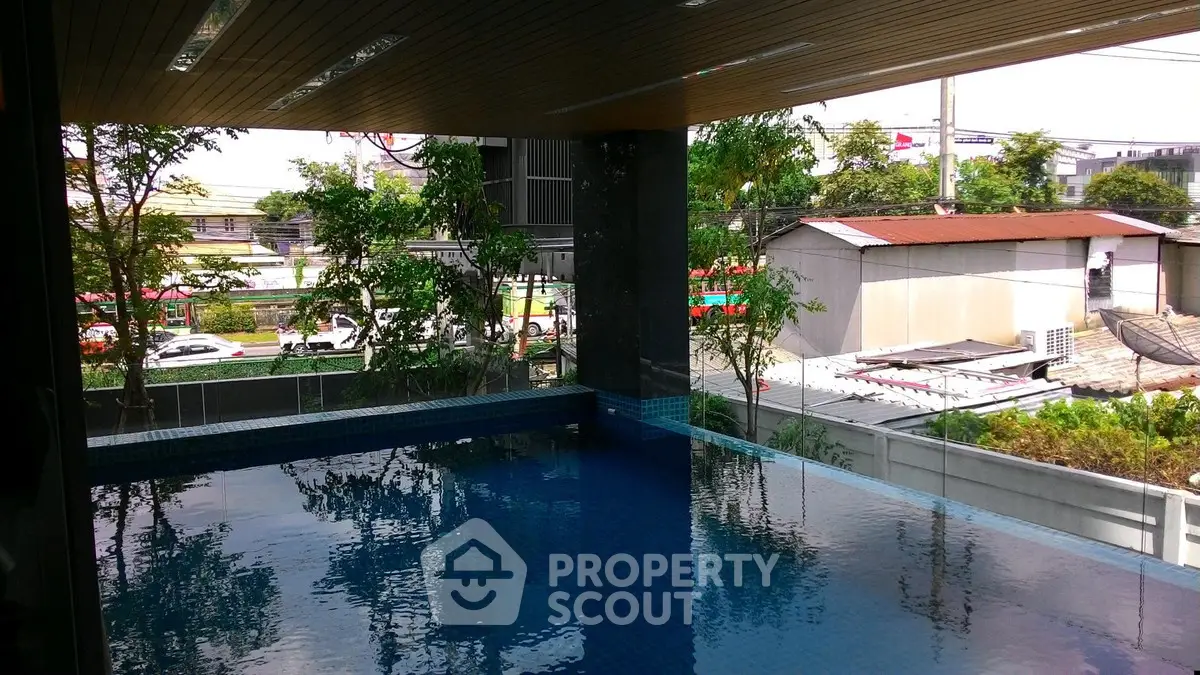 Luxurious modern pool with serene surroundings and lush greenery, perfect for relaxation and leisure.