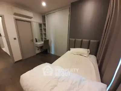 Cozy bedroom with modern decor and ample natural light