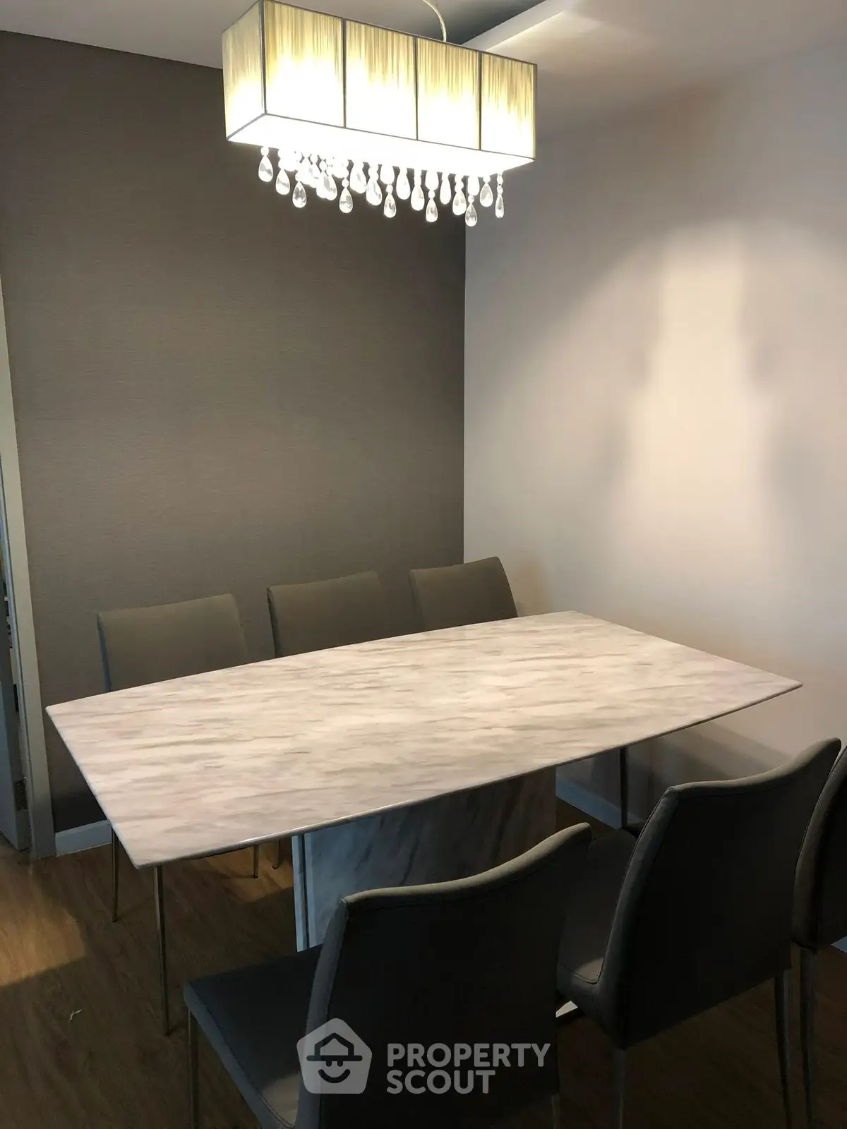 Elegant dining room with modern chandelier and sleek table setting