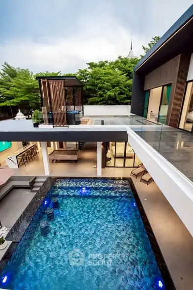 Luxurious modern home with stunning pool and spacious outdoor area, perfect for entertaining.