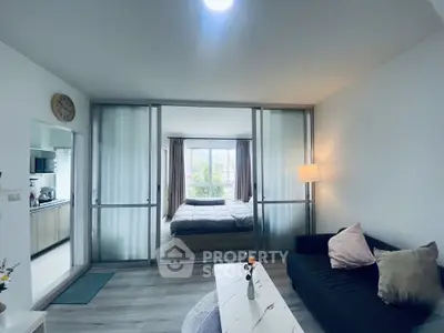 Modern open-plan living room with cozy bedroom and stylish kitchen