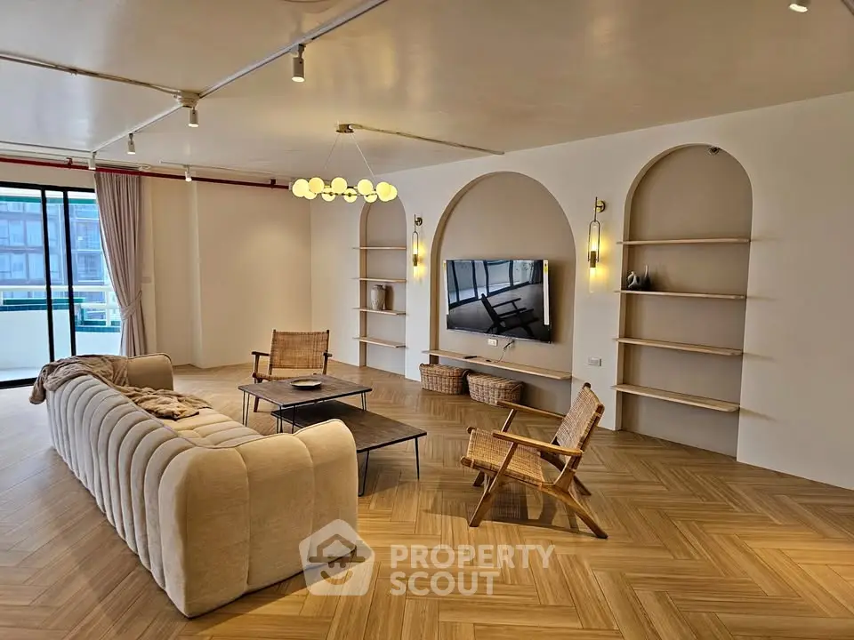 Spacious modern living room with elegant decor and large windows for natural light.