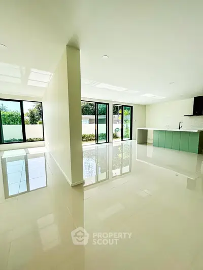 Spacious modern living room with open kitchen and large windows